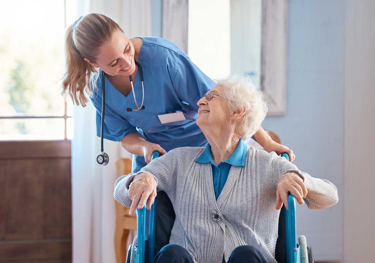 long-term care patient in wheelchair with nurse